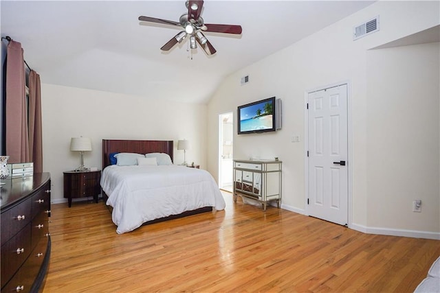 bedroom featuring ceiling fan, vaulted ceiling, and light wood-type flooring