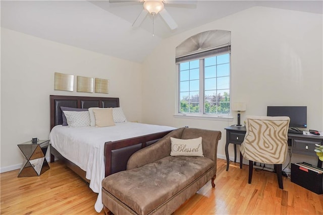 bedroom with ceiling fan, vaulted ceiling, and light wood-type flooring