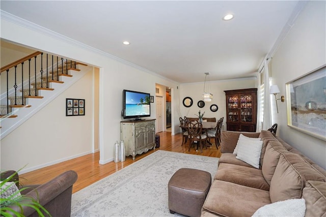 living room featuring wood-type flooring and ornamental molding