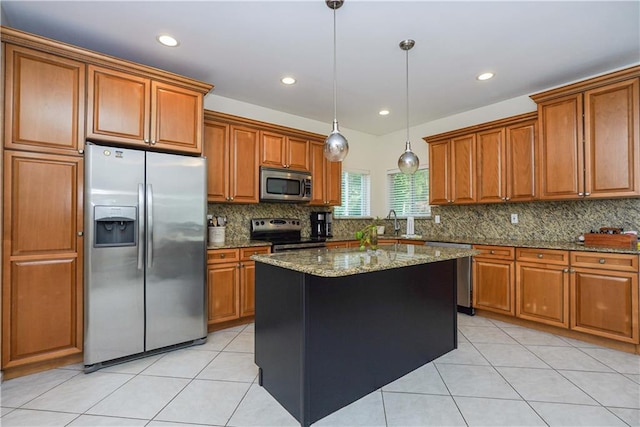 kitchen featuring light stone countertops, stainless steel appliances, light tile patterned floors, decorative light fixtures, and a kitchen island