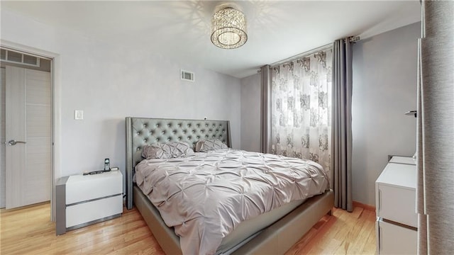 bedroom featuring light wood-type flooring and visible vents