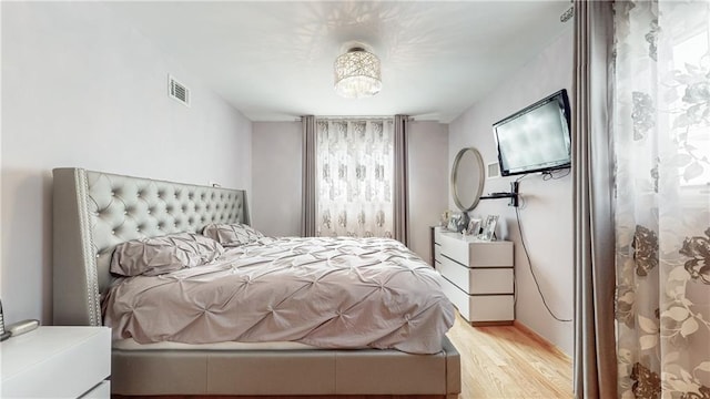 bedroom with visible vents and light wood-style floors