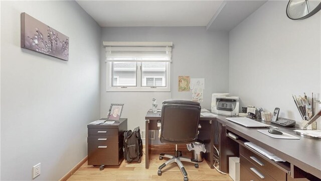 office area with light wood-type flooring and baseboards