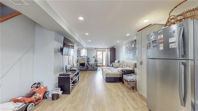 living room featuring visible vents, light wood-style flooring, and recessed lighting