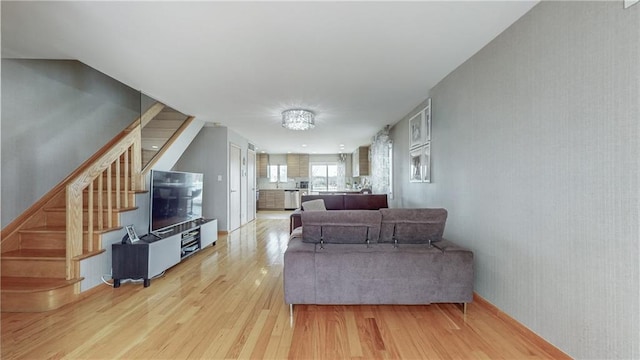 living area with stairs and light wood-type flooring