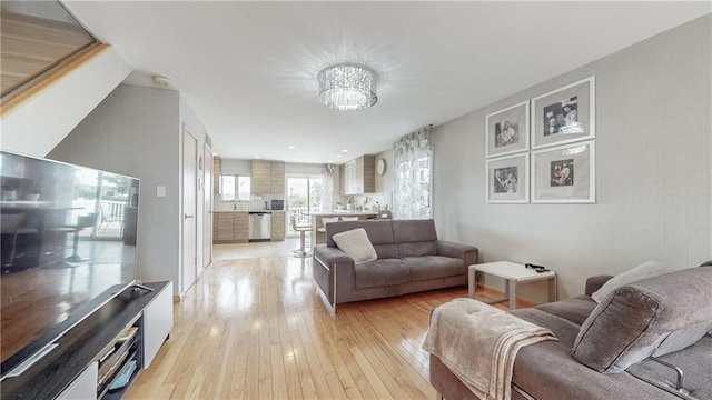 living room featuring light hardwood / wood-style flooring and a chandelier