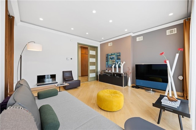 living room featuring ornamental molding and hardwood / wood-style flooring