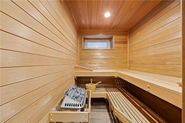 view of sauna with hardwood / wood-style flooring, wooden walls, and wood ceiling