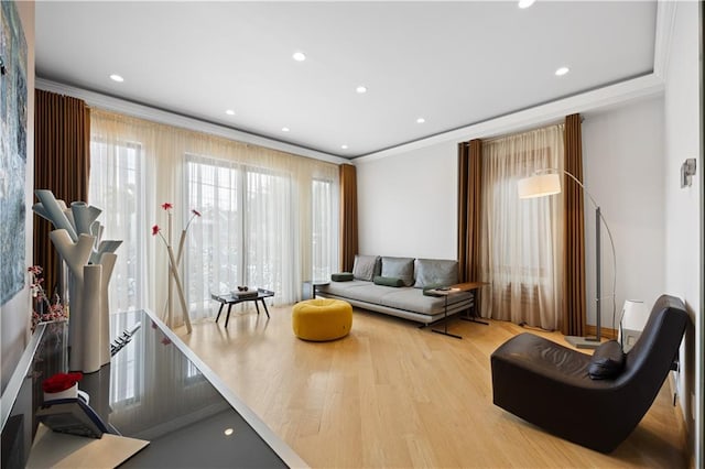 living room featuring light hardwood / wood-style flooring and crown molding