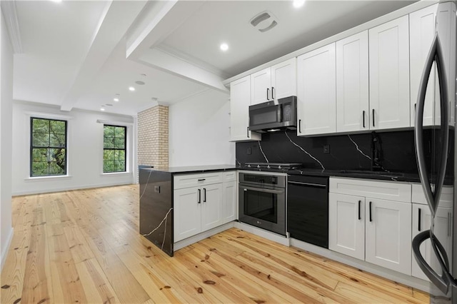 583 Putnam Ave Unit 3, Brooklyn, NY 11221 - kitchen with appliances with stainless steel finishes, a peninsula, light wood-style floors, dark countertops, and decorative backsplash