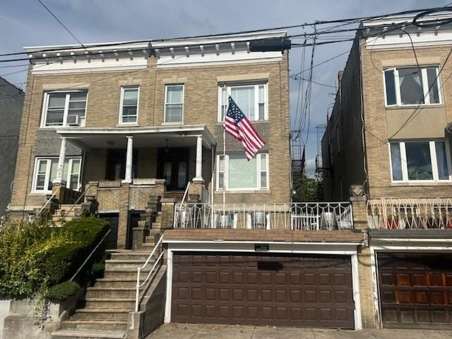 townhome / multi-family property with a porch and a garage