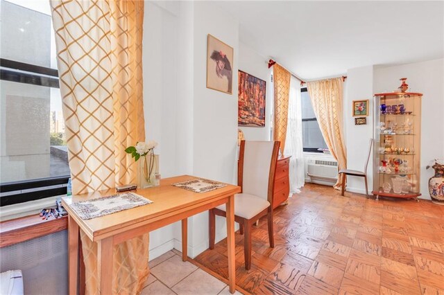 office space featuring a wall mounted AC and light parquet floors