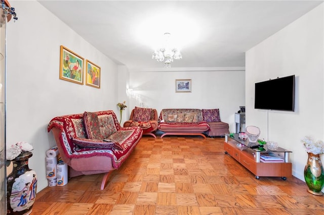 living room with light parquet floors and an inviting chandelier