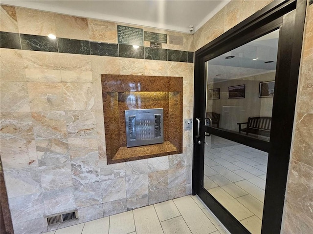 bathroom featuring tile walls