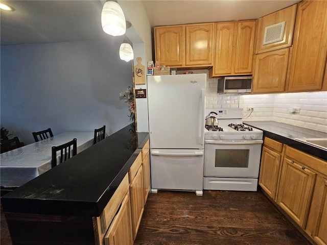 kitchen featuring decorative backsplash, white appliances, dark hardwood / wood-style floors, and decorative light fixtures