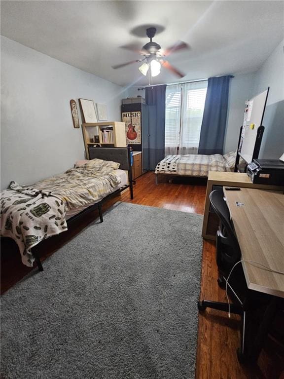 bedroom with dark wood-type flooring and ceiling fan