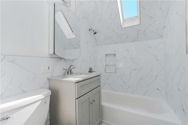 full bathroom featuring vanity, a skylight, toilet, and shower / bath combination