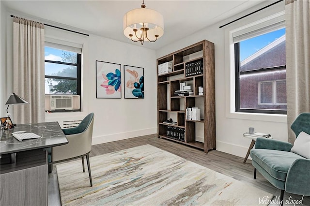 home office with a notable chandelier, cooling unit, wood finished floors, and baseboards