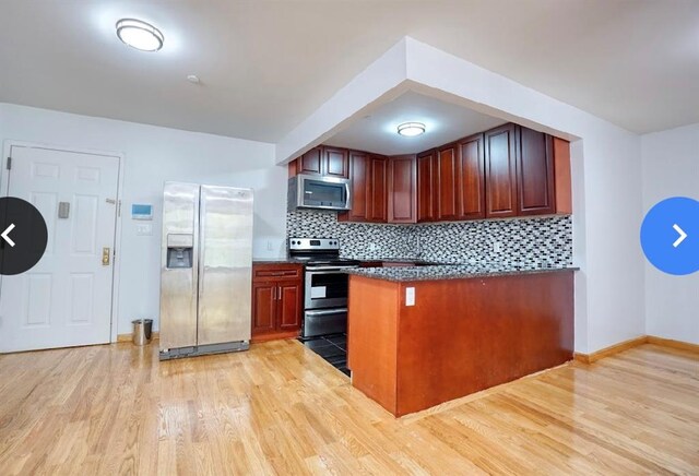 kitchen with decorative backsplash, light hardwood / wood-style flooring, and appliances with stainless steel finishes