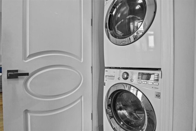 laundry area with stacked washer and clothes dryer