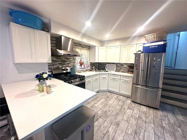 15 Bay 20th St, Brooklyn, NY 11214 - kitchen with wall chimney range hood, stainless steel appliances, a peninsula, and light countertops