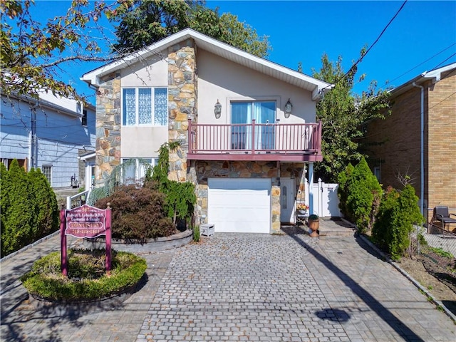 view of front of property with a balcony and a garage