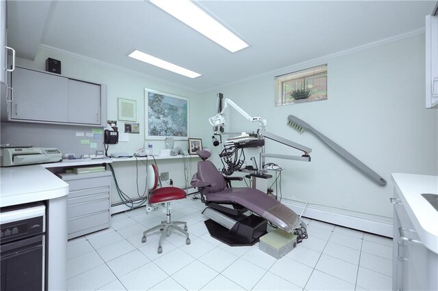 workout area featuring ornamental molding and light tile patterned floors