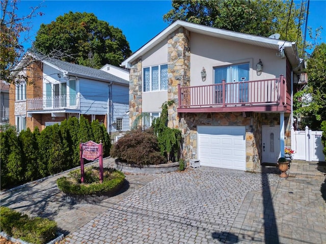 view of front of home with a garage and a balcony