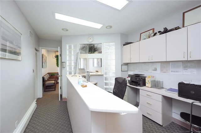 home office featuring dark colored carpet