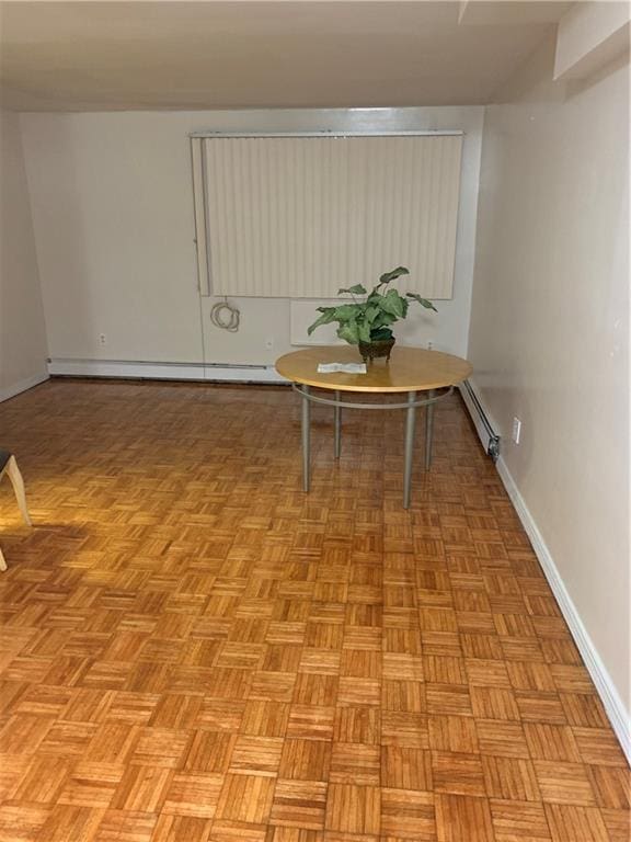 interior space featuring a baseboard heating unit, baseboards, and baseboard heating