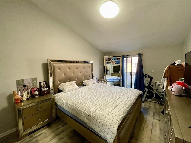 bedroom with hardwood / wood-style flooring and lofted ceiling