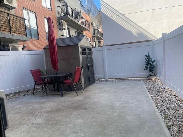 view of patio / terrace with a balcony and a shed