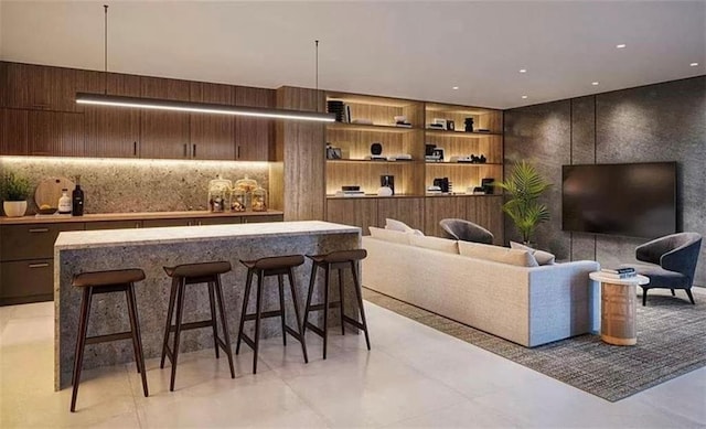 living room featuring dark brown cabinets and bar