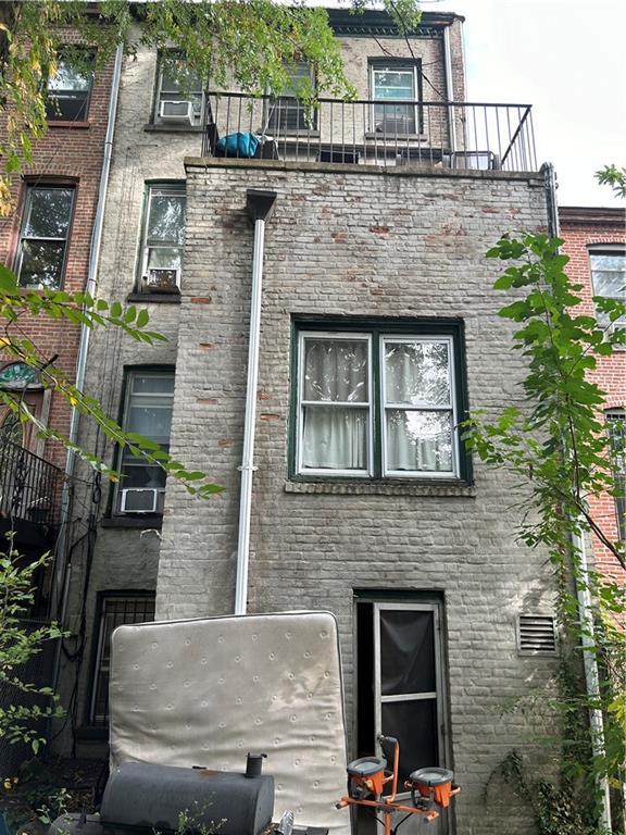 rear view of property featuring a balcony