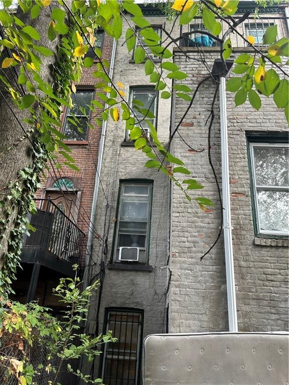 view of side of property with a balcony and cooling unit