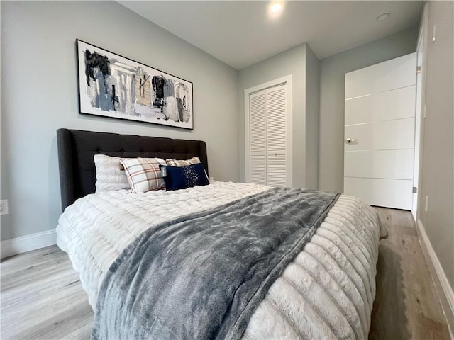 bedroom with a closet and light hardwood / wood-style flooring