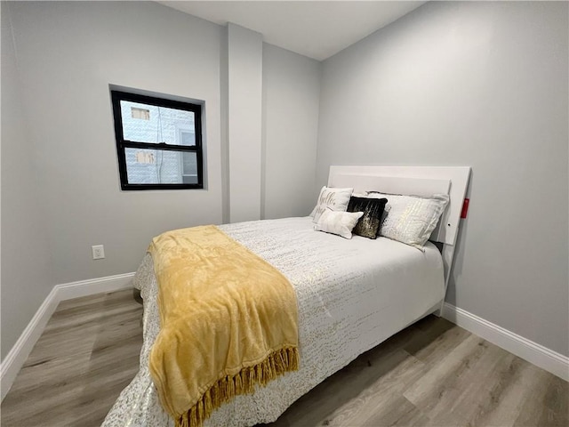 bedroom with hardwood / wood-style flooring