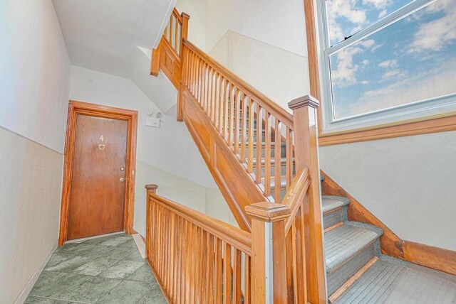 staircase with vaulted ceiling