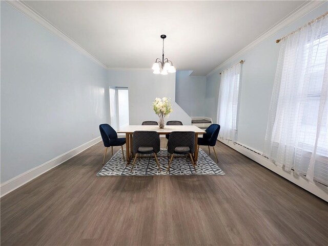 dining area with crown molding, dark hardwood / wood-style floors, a chandelier, and baseboard heating