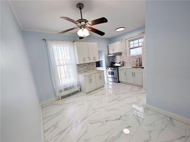 kitchen featuring sink, white cabinets, backsplash, ornamental molding, and gas stove