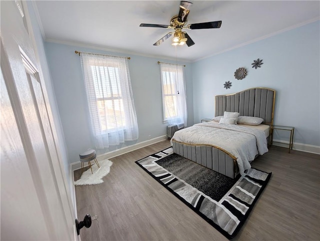 bedroom featuring radiator, crown molding, wood-type flooring, and ceiling fan