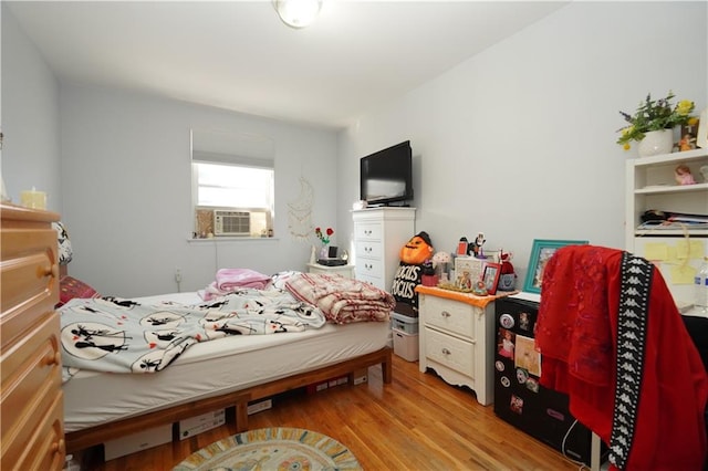 bedroom featuring light hardwood / wood-style floors and cooling unit