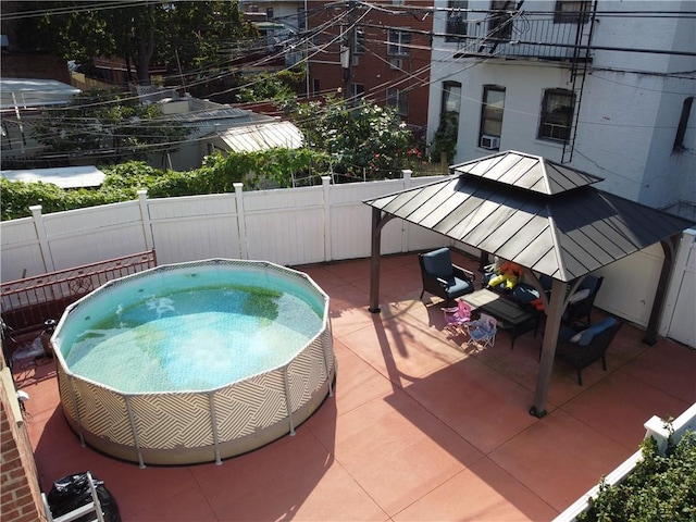 view of swimming pool featuring a patio and a hot tub