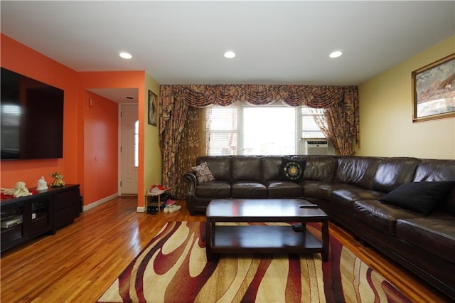 living room with cooling unit and light hardwood / wood-style floors