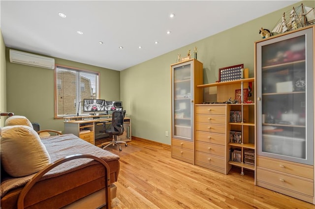 office area featuring light hardwood / wood-style floors and an AC wall unit