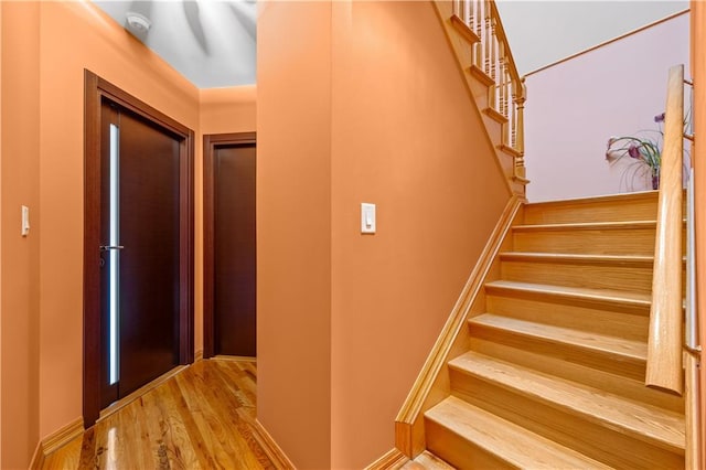 stairs featuring hardwood / wood-style flooring