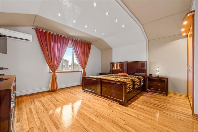 bedroom with light hardwood / wood-style flooring, a wall mounted air conditioner, and lofted ceiling