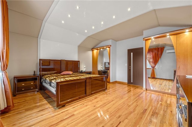 2643 E 24th St Unit 3A, Brooklyn, NY 11235 - bedroom with lofted ceiling, an AC wall unit, recessed lighting, and light wood finished floors
