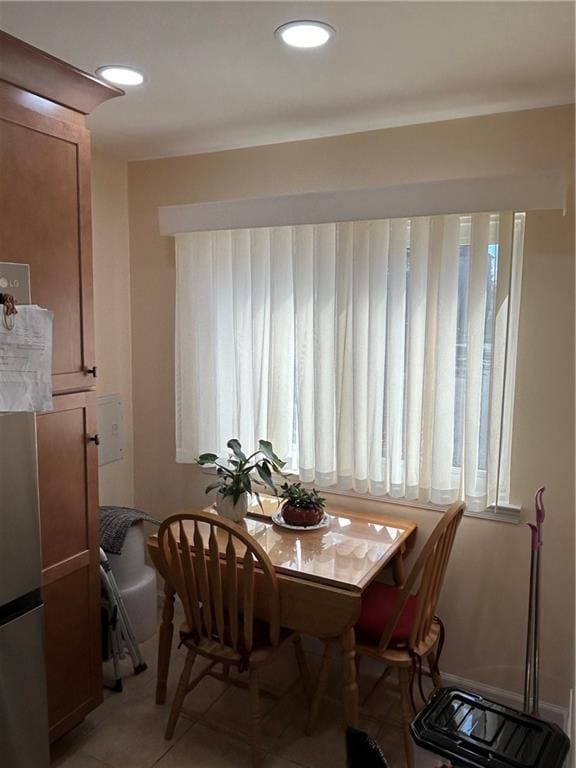 dining area featuring light tile patterned flooring