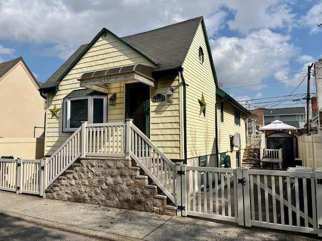 view of front of property featuring fence and a gate